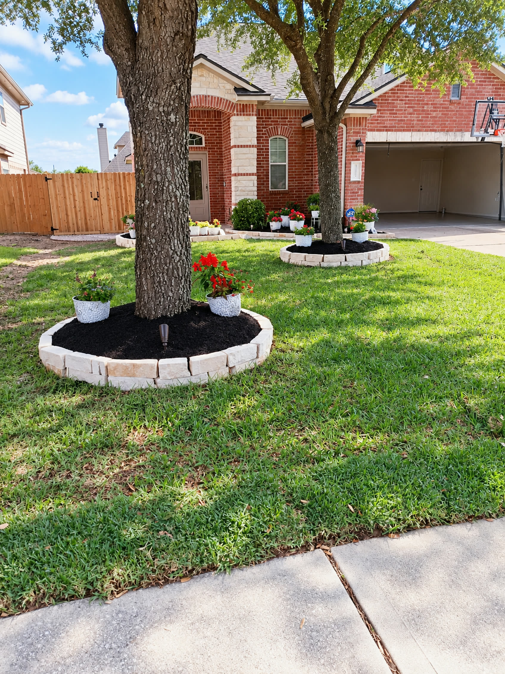 Front yard with circular mulched tree beds and a landscaped entry